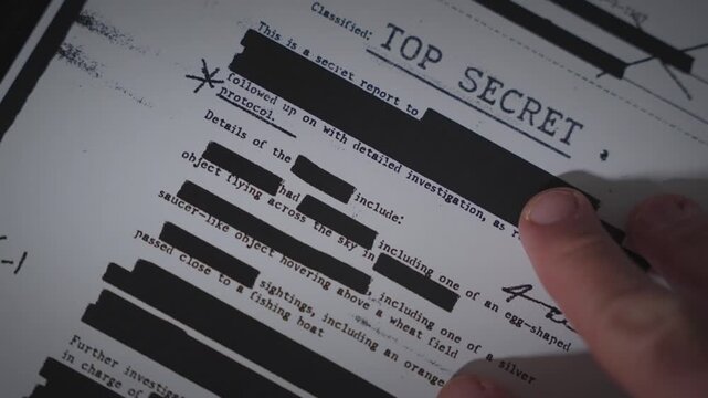 Hand laying down top secret document on scanner tray to copy or scan to computer. Digitizing sensitive government information. Compromising secrets and exposing fraud conspiracy of government agency