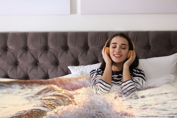 Happy woman listening to sounds of nature which making her feel calm. Double exposure of bedroom and sea waves
