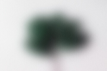 A single lush green tree stands against a soft white background, symbolizing growth and nature.