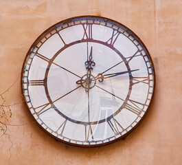 Close-up of a large vintage wall clock on a historic building.