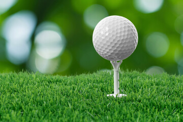 Golf ball on green grass against blurred background