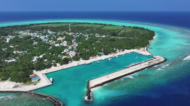 Aerial view of Thoddoo Island, where lush greenery meets white sandy beaches and turquoise waters, creating a stunning tropical paradise, Thoddoo, Alif Alif Atoll, Maldives.