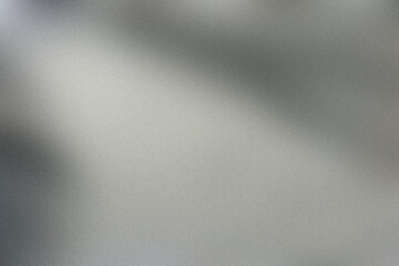 Soft light streaming across a textured grey surface