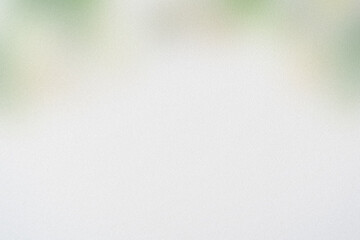 Soft, blurred background with subtle green and yellow hues, evoking a gentle, airy atmosphere.