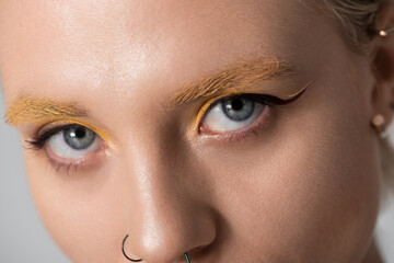 Stylish young woman showcases bold fashion and artistic makeup for a striking portrait