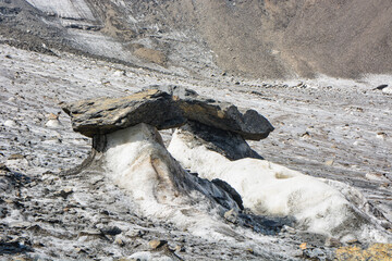 Idyllic summer landscape with glacier in the mountains with beautiful stones and ice cracks. Alai...