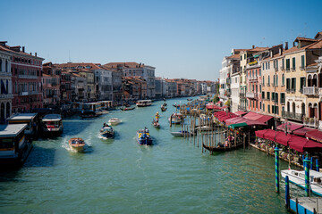 Grand Canal in Venice filled with gondolas and boats surrounded by colorful facades and historic Venetian architecture, capturing the lively spirit and iconic charm of Italy