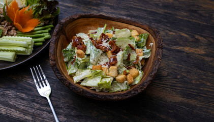 Ceasar Salad  in wooden bowl with bacon bit