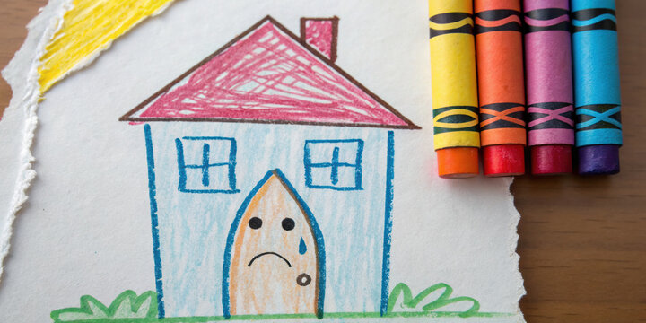 Sad child drawing of crying house shows emotional impact of real estate recession and home foreclosure. This art represents family trouble during financial crisis