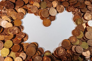 Euro cent coins arranged around an empty heart shaped space, symbolizing love, money, finance, and...