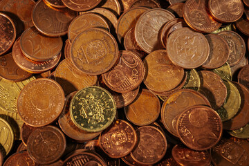 Pile of euro cent coins in various denominations, showing copper and brass tones, symbolizing small change, currency circulation, and everyday transactions.
