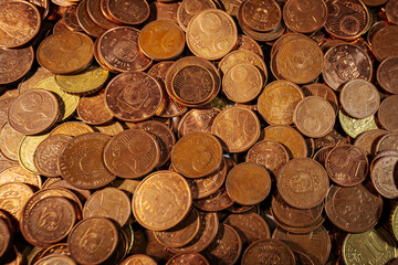 Pile of euro cent coins in various denominations, showing copper and brass tones, symbolizing small change, currency circulation, and everyday transactions.