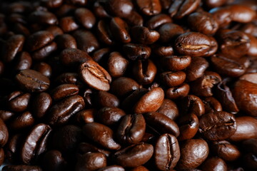 Close-up of roasted coffee beans background – macro texture of aromatic brown coffee seeds