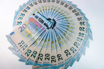 Circular arrangement of 20 euro banknotes spread out like a fan on a white background, symbolizing finance, savings, and monetary wealth.