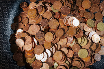 A frying pan filled with euro cent coins, symbolizing money, savings, financial struggles, or the...