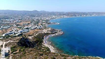 Aerial view backwards over the rocky coastline of Rhodes, sunny day in Greece