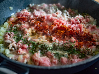 Frying bolognese sauce - minced pork meat with onion in frying pan