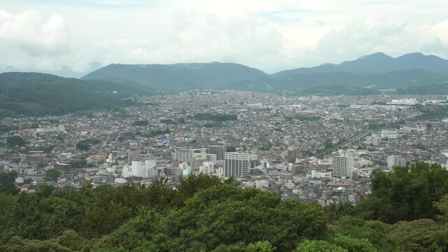 View of Hadano City from Koboyama Park after Hiking. Hadano City is a city of Kanagawa Prefecture, Japan. The view from the park gives a nice contrast of forest and buildings.