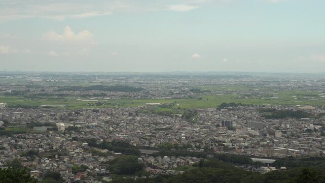 View of Hadano City from Koboyama Park after Hiking. Hadano City is a City of Kanagawa Prefecture, Japan. The view shows rice fields and buildings co-existing.
