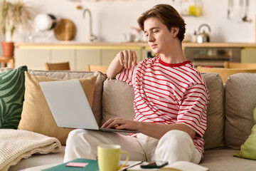 Young man engaging in online studies from his stylish apartment
