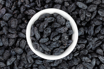 black raisins as a background. Top view. Flat lay