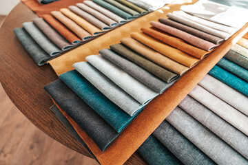 Fabric samples for custom furniture and interior design, textile swatches for choosing upholstery color, texture and material in modern home decoration.
