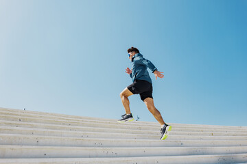 Runner ascends outdoor stairs during daytime exercise session