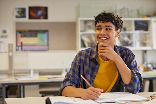 Happy teenager student thinking at secondary classroom