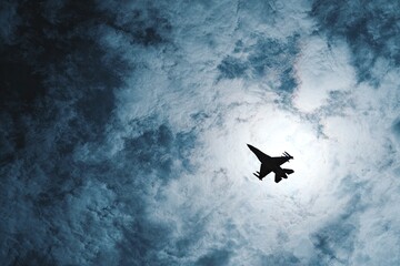 Fighter jet in stormy sky