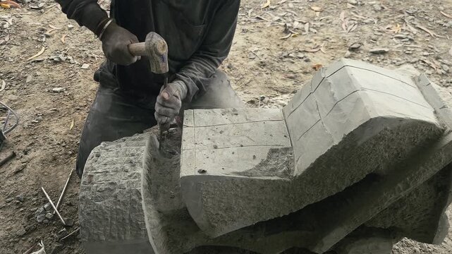 Stone Carving - Stone Art in India. Indian stone mason Creating abstract sculpture Of granite Stone. Cutting rock with grinder, chisel and hammer with traditional technique. Slow Motion 4k Footage