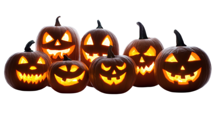 Creepy carved pumpkins with glowing faces in spooky group arrangement isolated on transparent background 