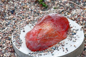 Artificial amber in vivid colors on a round pedestal for outdoor use as decoration