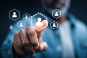 Hand reaches toward illuminated people icons representing digital networking and professional connections.