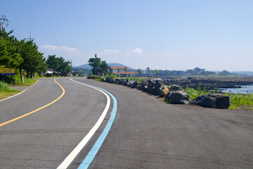 Fototapeta premium Blue‑Line Road by Jinseon Fisheries