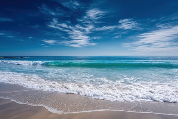 Fototapeta premium Sunny Beach with Blue Sky and Rolling Waves
