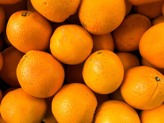 Ripe, juicy oranges are evenly arranged to create a full-frame flat surface, perfect for...
