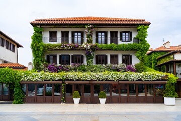 Beautiful building with flowers and plants covering the exterior walls and balconies