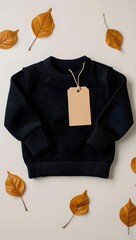 Autumn sweater with tag and leaves on white background for fall fashion sale image