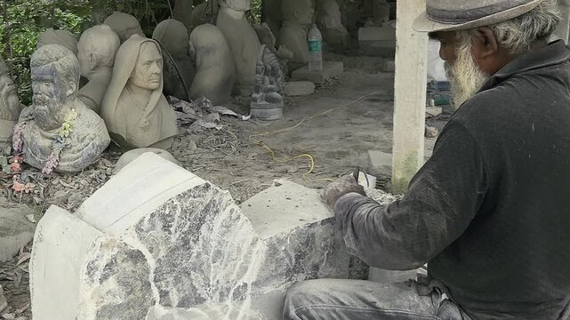 Stone Carving - Stone Art in India. Indian stone mason Creating abstract sculpture Of granite Stone. Cutting rock with grinder, chisel and hammer with traditional technique. Slow Motion 4k Footage