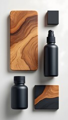 Black bottles and wood accents on a white background in a studio setting