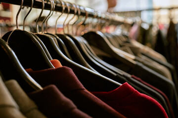 Clothes on hangers in a fashion store with no people