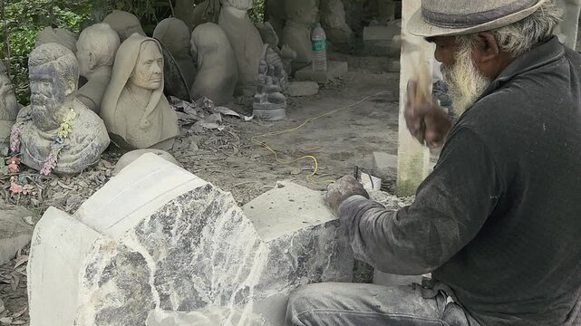 Stone Carving - Stone Art in India. Indian stone mason Creating abstract sculpture Of granite Stone. Cutting rock with grinder, chisel and hammer with traditional technique. Slow Motion 4k Footage