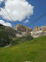 View From Sass Pordoi In Dolomites on a Summer Day, Cable Car Lines Over A Mountain - Italy