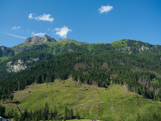 Summer Day In The Italian Dolomite, Canazei's Majestic Mountain Under Blue Sky, Italy