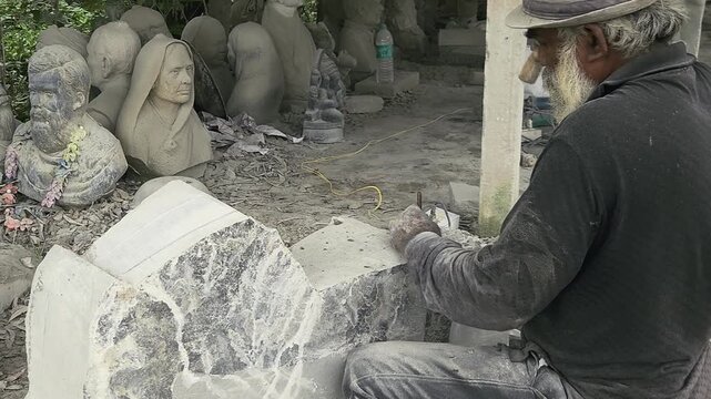 Stone Carving - Stone Art in India. Indian stone mason Creating abstract sculpture Of granite Stone. Cutting rock with grinder, chisel and hammer with traditional technique. Slow Motion 4k Footage