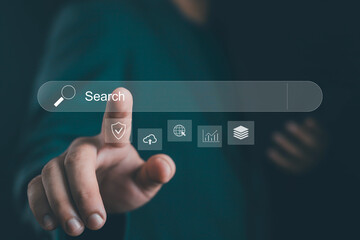Close-up of hand touching virtual search bar with digital icons for security, cloud, global internet, analytics, and data, symbolizing online search, SEO, technology, and digital transformation.