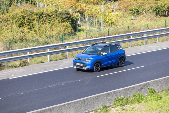 Blue citroen c3 aircross suv driving on highway