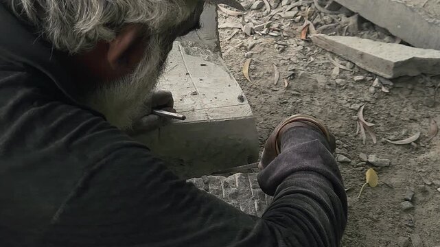 Stone Carving - Stone Art in India. Indian stone mason Creating abstract sculpture Of granite Stone. Cutting rock with grinder, chisel and hammer with traditional technique. Slow Motion 4k Footage
