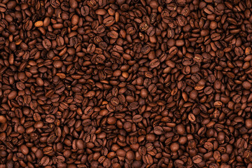 Freshly roasted coffee beans background texture. Close-up, top view.