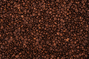 Freshly roasted coffee beans background texture. Close-up, top view.